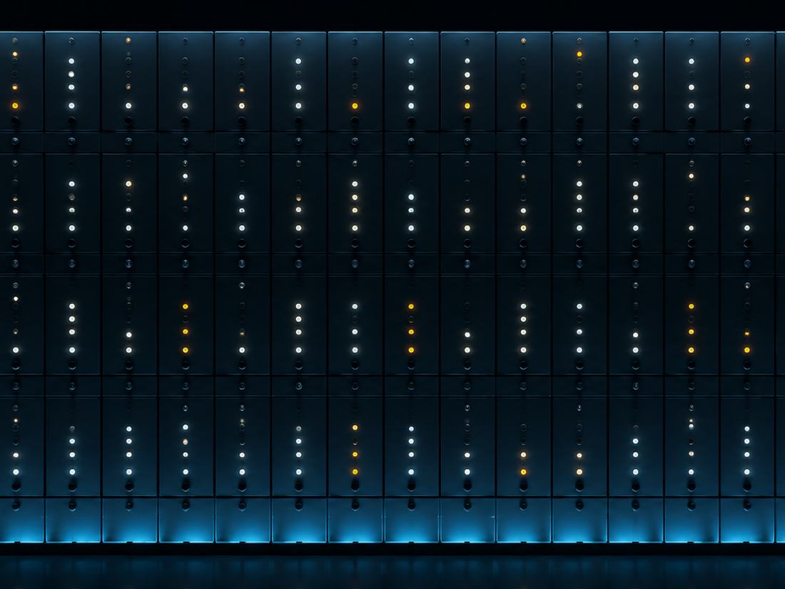 A row of server racks in a data centre, status lights running the length of the aisle.